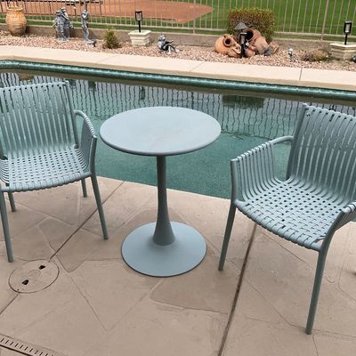 Sale Photo Thumbnail #45: Three-piece modern outdoor patio bistro set featuring two light blue woven metal armchairs and a matching pedestal bistro table.
