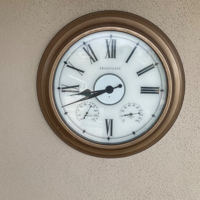 Sale Photo Thumbnail #16: Large Frontgate outdoor wall clock with bronze-finished metal frame, Roman numerals, and built-in temperature and humidity gauges.
