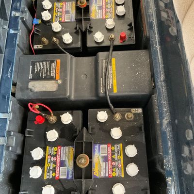 Sale Photo Thumbnail #10: Set of four Crown deep cycle 8V golf cart batteries wired in series inside a battery compartment.