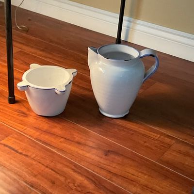 Sale Photo Thumbnail #80: Pair of white ceramic kitchen items, including a water pitcher and a four-lug mortar or bowl, featuring blue-rimmed trim.