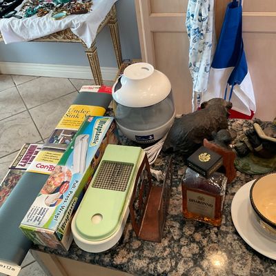 Sale Photo Thumbnail #109: Collection of household goods including a white cool mist humidifier, vintage green food chopper, decorative bear figurines, and kitchen wrap dispensers.