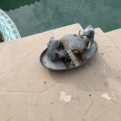 Sale Photo Thumbnail #26: Vintage painted metal garden statue depicting two frogs sitting in a boat under an umbrella, showing weathered finish and surface rust.