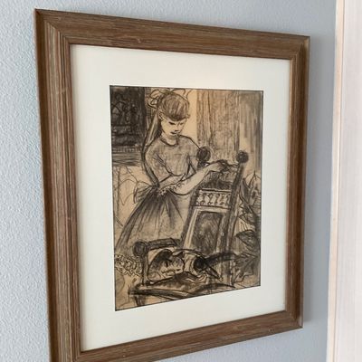 Sale Photo Thumbnail #116: Framed charcoal or pencil sketch of a young girl with a cat resting nearby, presented in a matted wooden frame.