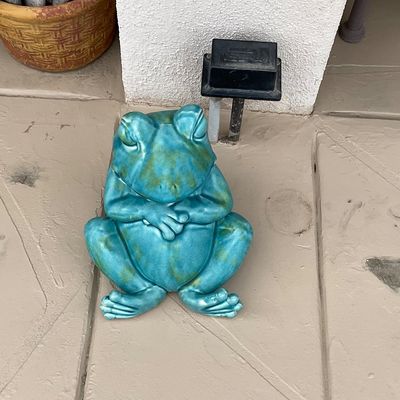 Sale Photo Thumbnail #43: Glazed ceramic frog garden statue finished in a mottled turquoise and green glaze, depicting a sitting frog with folded arms.