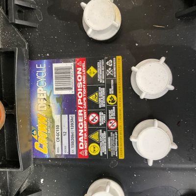 Sale Photo Thumbnail #11: Crown Deep Cycle 12-volt battery model CR-GC150 featuring white twist-off vent caps and safety warning labels.