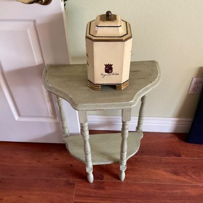 Sale Photo Thumbnail #69: Distressed light green painted demi-lune console table with turned legs, featuring a Raymond Waites ceramic jar on top.