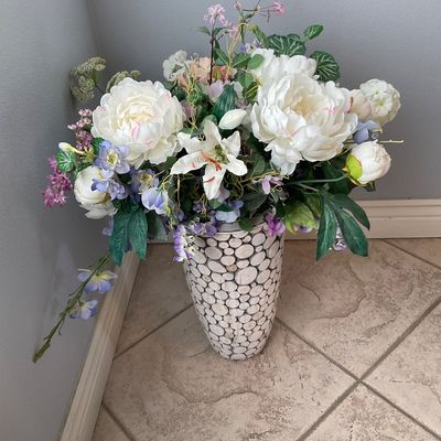 Sale Photo Thumbnail #119: Large faux floral arrangement featuring white peonies, lilies, and purple accent flowers, set in a wood cross-section mosaic floor vase.