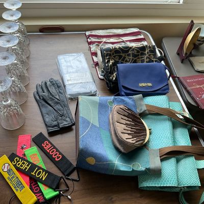 Sale Photo Thumbnail #146: Collection of women's accessories and home goods, including handbags, stemware, leather gloves, novelty keychain tags, and a Kenneth Cole Reaction crossbody bag.