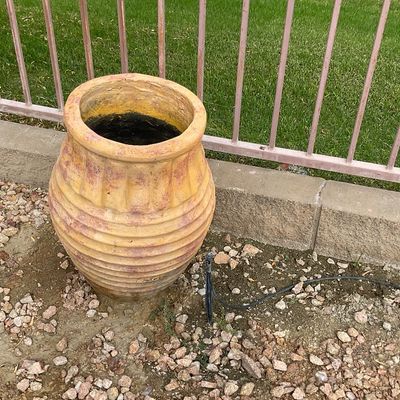 Sale Photo Thumbnail #33: Large terracotta-style garden urn planter with horizontal ribbed texture and a weathered, multi-tone yellow finish.