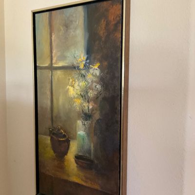 Sale Photo Thumbnail #154: Framed impressionistic still life oil painting depicting flowers in a vase by a window, housed in a thin wooden frame with a brass edge.