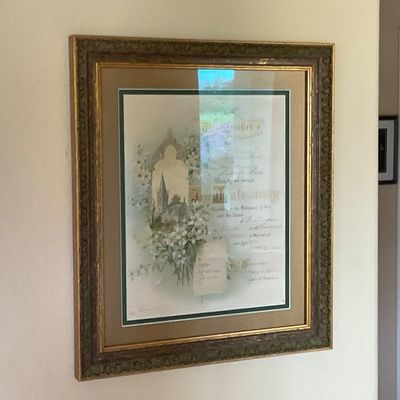 Sale Photo Thumbnail #58: Framed antique marriage certificate featuring intricate floral illustrations and calligraphy, housed in an ornate carved gold-tone wooden frame.