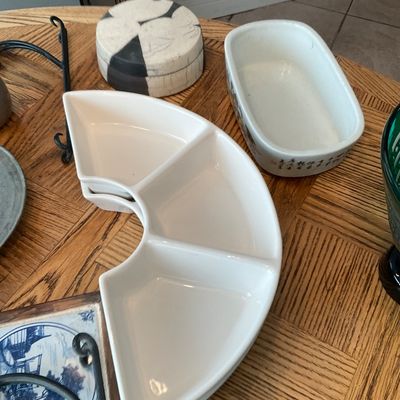 Sale Photo Thumbnail #125: Collection of decorative ceramic tableware including white curved divided relishing dishes, a raku-style covered box, and a Asian porcelain planter.
