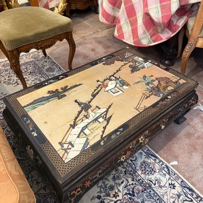 Vintage Asian-style low coffee table featuring an inset top panel depicting figures in a landscape with mother-of-pearl inlays and...