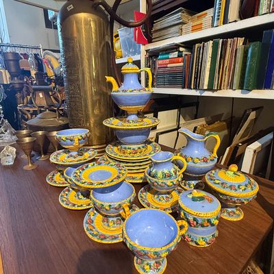 Hand-painted Italian Deruta-style ceramic tea and coffee set featuring vibrant blue glaze, yellow trim, and floral accents, displayed...