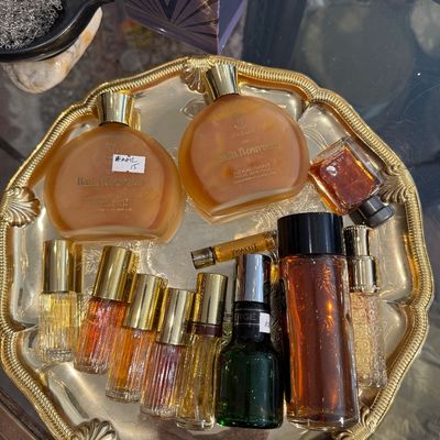 Collection of vintage perfume and fragrance bottles, including Houbigant Bain Nouveau and various mini atomizers, displayed on a...