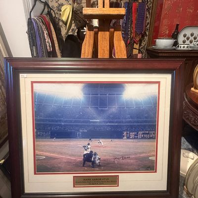 Framed and matted Hank Aaron signed photograph commemorating his 715th home run on April 8, 1974, set in a dark wood frame.