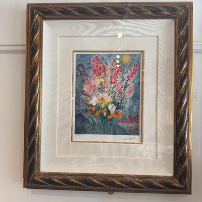 Framed Marc Chagall art print depicting a vibrant floral bouquet, housed in an ornate twist-carved gilt frame with a wide white mat.