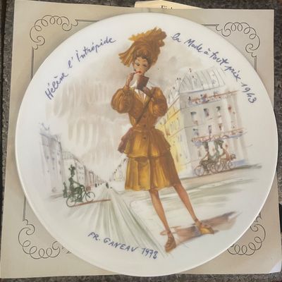 Sale Photo Thumbnail #10: Limoges porcelain collector's plate featuring a fashion illustration titled 'Hélène l'Intrépide' by François Ganeau, produced in 1978.