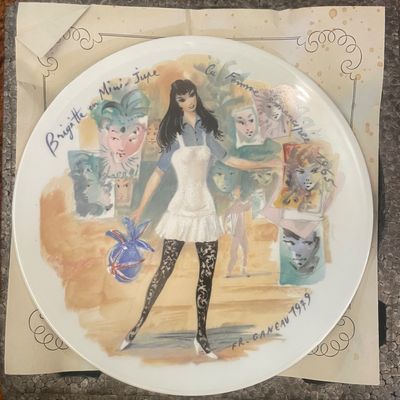 Sale Photo Thumbnail #9: Limoges porcelain collector plate titled "Brigitte en Mini-Jupe," signed by artist Francois Ganeau and dated 1979.