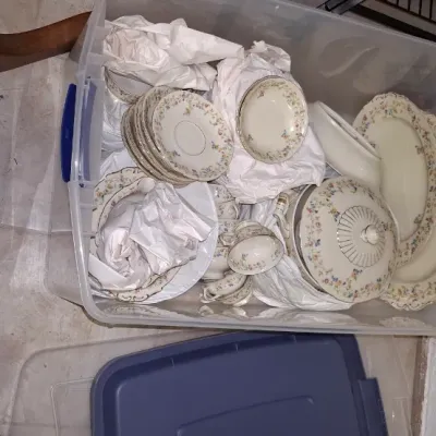 Sale Photo Thumbnail #204: Large clear plastic storage bin filled with vintage floral china dinnerware, wrapped in tissue paper for protection.