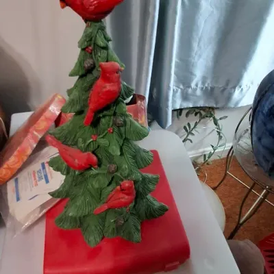 Sale Photo Thumbnail #125: Painted resin Christmas tree figurine decorated with bright red cardinals sitting atop a red base.