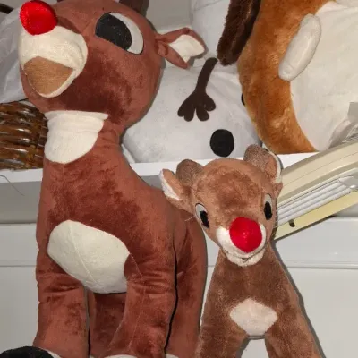 Collection of plush holiday characters, featuring Rudolph the Red-Nosed Reindeer in two sizes alongside an Olaf snowman plush, shown in...