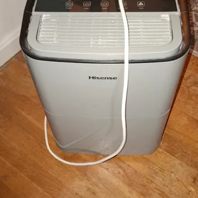 Sale Photo Thumbnail #266: Hisense portable dehumidifier featuring top digital controls, front air vent, and attached power cord.