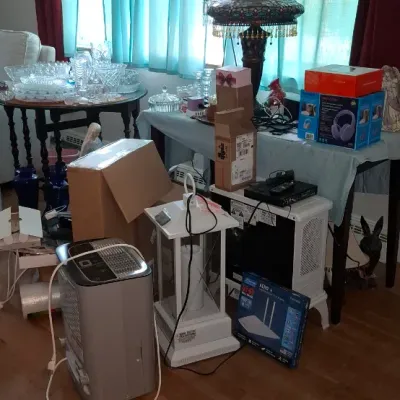 Sale Photo Thumbnail #279: Collection of home goods and small appliances, including a Portable dehumidifier, decorative stained glass table lamp, cut crystal glassware, and boxed electronics.