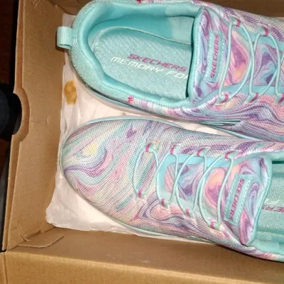 Pair of women's Skechers Memory Foam sneakers featuring a pastel tie-dye marble pattern, presented inside their original cardboard box.