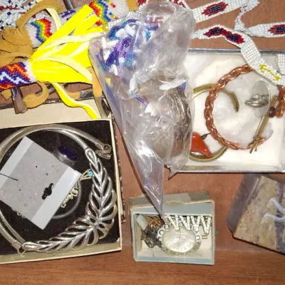 Sale Photo Thumbnail #145: Collection of Southwestern and Native American style jewelry, including beadwork, silver-tone collar necklaces, copper bangles, and small keepsake boxes.