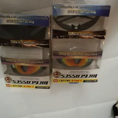 Sale Photo Thumbnail #104: Two boxed sets of Bell+Howell TacGlasses, featuring 3-pack value sets with polarized and night vision lenses, along with additional packaged items.