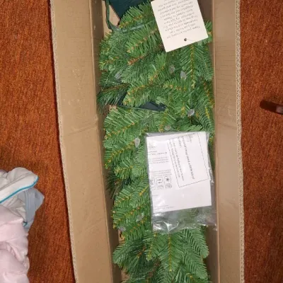 Sale Photo Thumbnail #137: Cardboard box containing a set of pre-lit artificial Christmas garland or pathway trees, complete with ground stakes, solar panels, and instruction manuals.