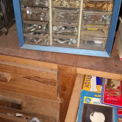 Sale Photo Thumbnail #229: Vintage blue metal multi-drawer parts organizer filled with various hardware items including screws, nuts, and bolts.