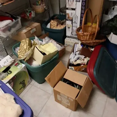 Sale Photo Thumbnail #165: Assorted household items, plastic storage totes, cardboard shipping boxes, and a boxed Shark Navigator Professional vacuum stored in a utility area.