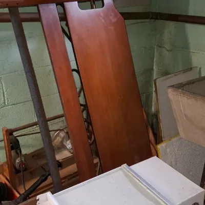 Sale Photo Thumbnail #156: Vintage wooden ironing board and household items stored in a basement room near electrical panels.