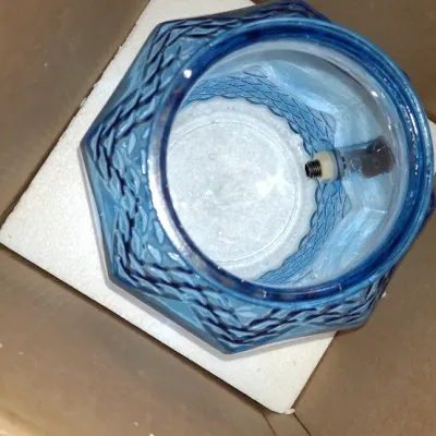 Blue pressed glass vessel or lamp base with a textured diamond pattern, packed inside a cardboard box with foam insert.