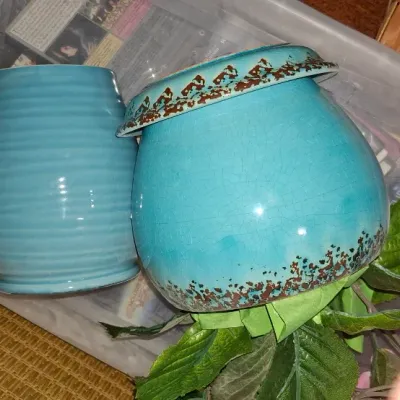 Two turquoise ceramic vessels, including a ribbed vase and a self-watering African violet pot with a distressed crackle glaze finish.