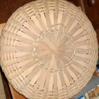 Sale Photo Thumbnail #138: Handwoven round split-wood basket featuring a sunburst bottom design, seen from the top.