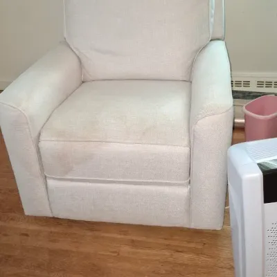 Sale Photo Thumbnail #252: Contemporary off-white upholstered armchair featuring a plush seat and high back cushion, shown in used condition alongside an air purifier.