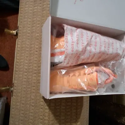 Pair of bright orange Easy Spirit athletic shoes, new in original box with tissue wrapping.
