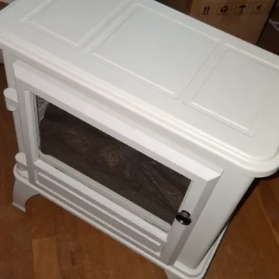 Sale Photo Thumbnail #268: White electric stove heater with simulated log insert and glass door, modern style in good condition.