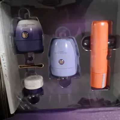 Sale Photo Thumbnail #110: Tatcha skincare gift set in original purple packaging, including cream jars and facial spray.