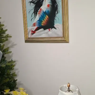 Sale Photo Thumbnail #134: Framed oil painting on canvas depicting a Native American woman wrapped in a colorful blanket, set in an ornate gilded frame.