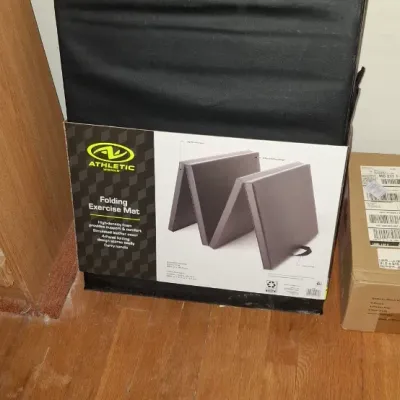 Athletic Works black folding exercise mat in its original packaging.