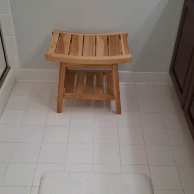 Sale Photo Thumbnail #35: Natural teak shower bench with a slatted curved seat and lower storage shelf.