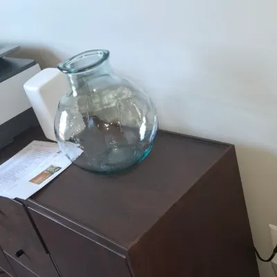 Sale Photo Thumbnail #13: Large clear recycled glass demijohn vase sitting atop a modern dark wood cabinet.