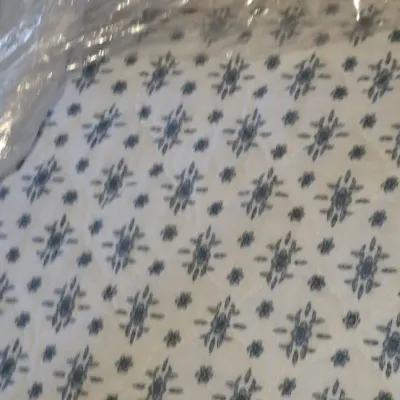 Sale Photo Thumbnail #53: Quilted mattress with a blue geometric medallion pattern, protected in a clear plastic storage bag.