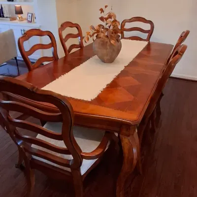 Sale Photo Thumbnail #26: Traditional French Country style dining table set with six ladder-back chairs featuring upholstered seats.