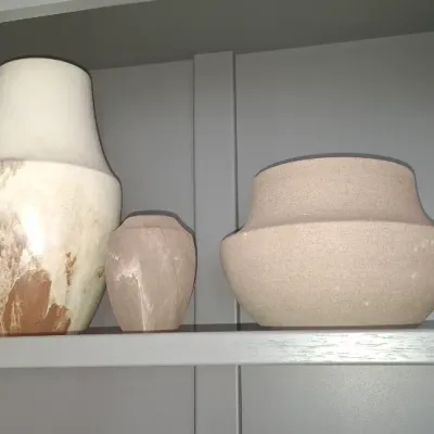 Sale Photo Thumbnail #15: Trio of decorative stone vessels, including a tall marbled onyx vase, a small matching onyx pot, and a wide speckled ceramic or stone bowl.