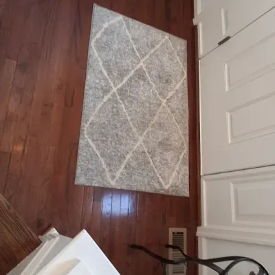 Sale Photo Thumbnail #57: Modern grey and white geometric diamond patterned area runner rug placed on hardwood flooring.